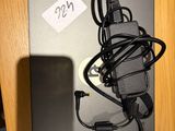 a laptop with a charger attached to it on a desk