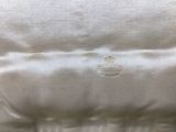 an image of a close up of a bed with a pillow on top of it