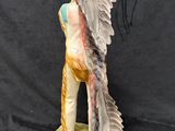 a statue of a man with wings on a black background