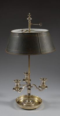 a silver plated table lamp with a black shade on it