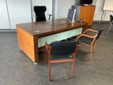 a wooden desk with a computer on top of it