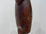 an image of a wooden sculpture of a man ' s head on a stand