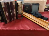a red table with a bunch of old accordions on it