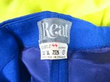 the label on the back of a blue shirt reads real