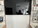 a television mounted on the wall in a small room