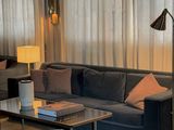 a living room with a couch, chair, table and lamp