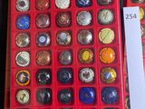 a lot of buttons in a red box on a table