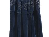 blue skirt hanging on a hanger against a white wall