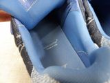 a close up of a pair of blue shoes with a label on them