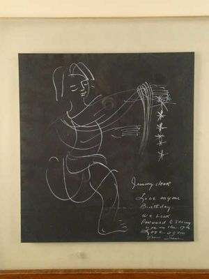 framed drawing of a man holding a knife in front of a blackboard