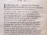 a close up of a book with writing on it and a clock in the background