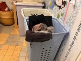 an image of a laundry basket in the corner of a room