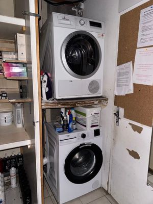 a washer and dryer in the corner of a room