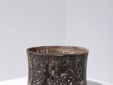 an image of a brown bowl sitting on top of a white table