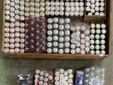 several cans of beer are in a wooden box on the floor