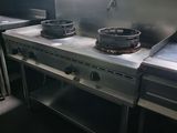 four burners on the stove in this restaurant kitchen