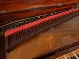 a piano that is sitting on top of a wooden table