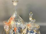 three glass bottles and a tray on a table