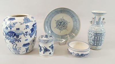 a group of blue and white vases and plates
