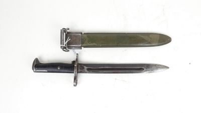 two knives are laying side by side on a white surface