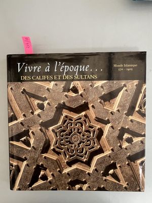 a book that is sitting on a table next to a clock