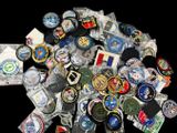a pile of badges and badges on a black background