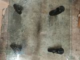 a glass table with wheels on it in a room