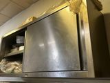 a kitchen with a stainless steel counter top and cabinets