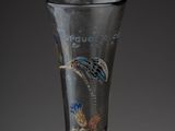 a glass vase with a design on it on a table