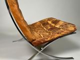 an image of a chair with a leather seat and a metal frame