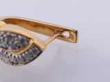 an image of a gold and diamond ring on a white surface
