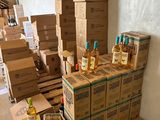 many boxes of liquor sitting on the floor in a room