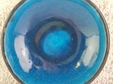 a blue bowl sitting on top of a white table