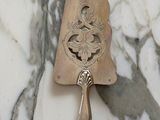 a silver spoon with a silver handle on a marble table