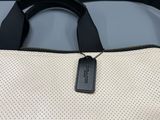 a close up of a white bag with a tag on it