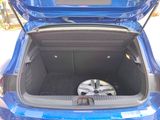 a blue car with its trunk open and a speaker in the trunk