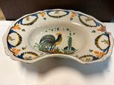 a bowl with a rooster on it on a table