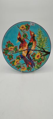 two birds on a branch of a tree with flowers on a blue plate