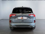 the rear end of a silver car in a showroom