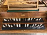 a wooden organ that is sitting on the floor