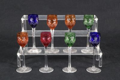 six wine glasses in a clear holder on a black background