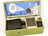 a green box with a picture of an angel and a camera inside of it