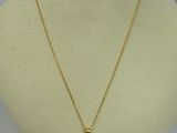 a white mannequin with a gold necklace on it