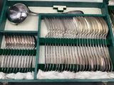 a green case with silverware in it on a table