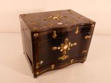 a small wooden chest with gold decorations on it