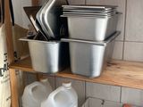 a shelf with pots and pans on it in a kitchen