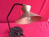 an image of a lamp on a table with a pink background