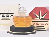 a small bottle of perfume sitting next to a box