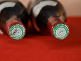 two bottles of wine that are sitting on a table