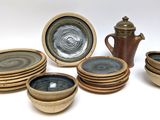 a lot of plates and cups that are sitting on a table